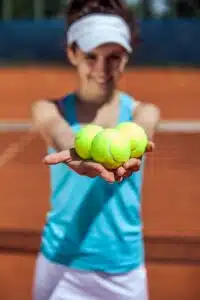 A Tennis Player Cary Tennis Balls